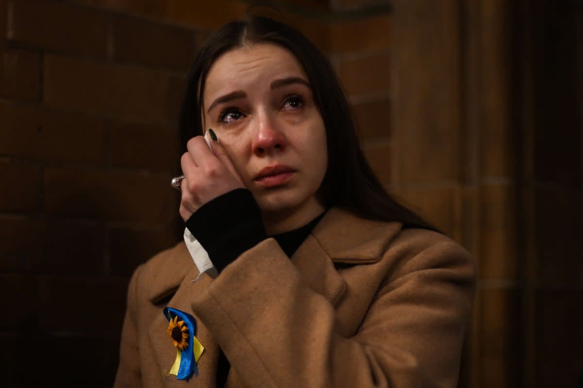 A woman dries her tears during the ecumenical prayer service at Ukrainian Catholic Cathedral, in London (AFP via Getty Images)