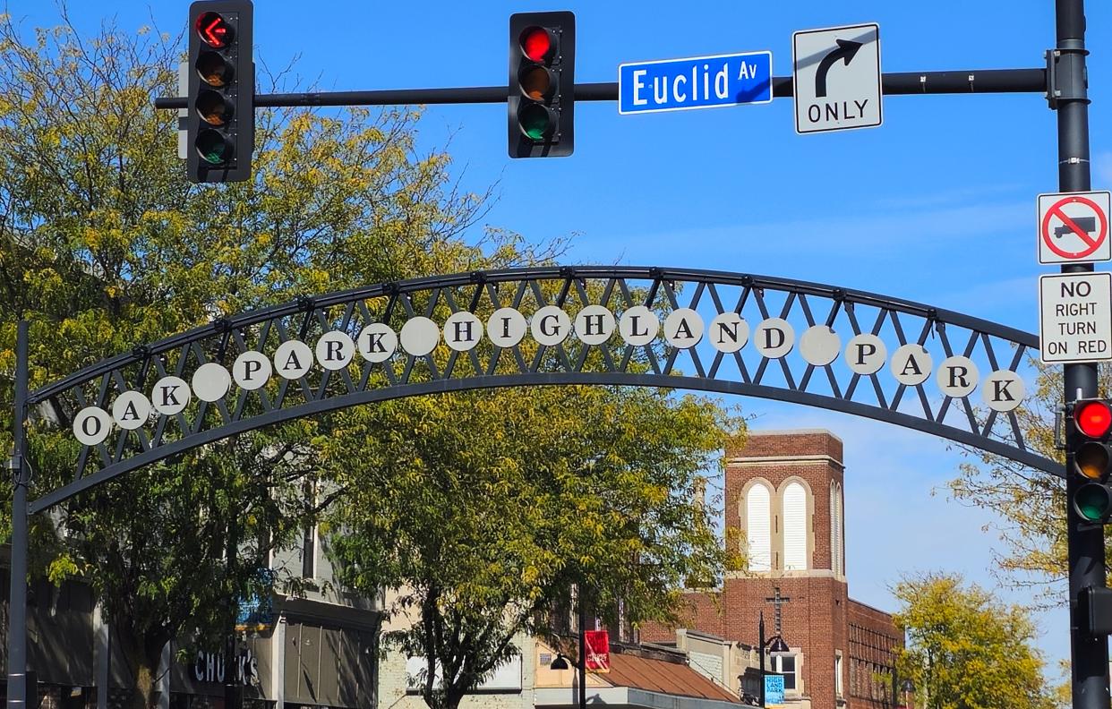 A sign spans across Sixth Avenue greeting visitors to Highland Park on the east and Oak Park on the west in Des Moines.