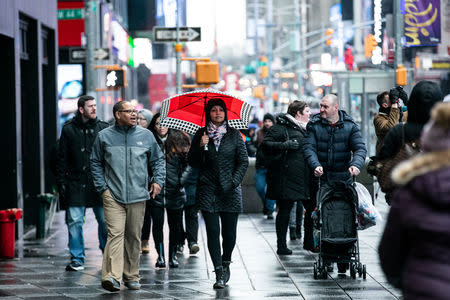 A pedestrians walks in the rainy day at Time Square in the Manhattan borough of New York City, New York, U.S., January 20, 2019.REUTERS/Jeenah Moon