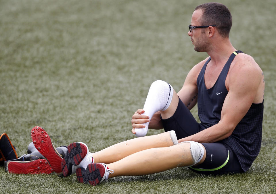 Oscar Pistorius of South Africa removes his prosthetic legs before wearing his running blades during a training session for the IAAF Daegu 2011 World Championship in Daegu August 24, 2011. REUTERS/Max Rossi (SOUTH KOREA - Tags: SPORT ATHLETICS) - RTR2Q93M