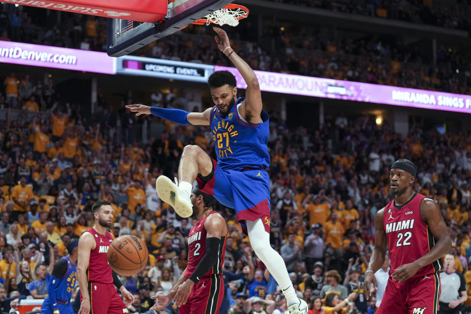 Denver Nuggets guard Jamal Murray, center, dunks against the Miami Heat during the first half of Game 1 of basketball's NBA Finals, Thursday, June 1, 2023, in Denver. (AP Photo/Jack Dempsey)