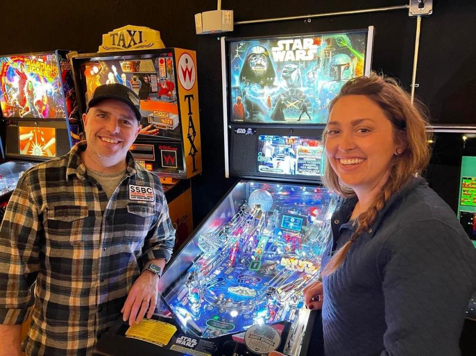 Andy and Amanda Conrad are shown in the arcade next to Sandy Springs Brewing Co. in Minerva. The arcade was added to the couple's brewery business late last year.