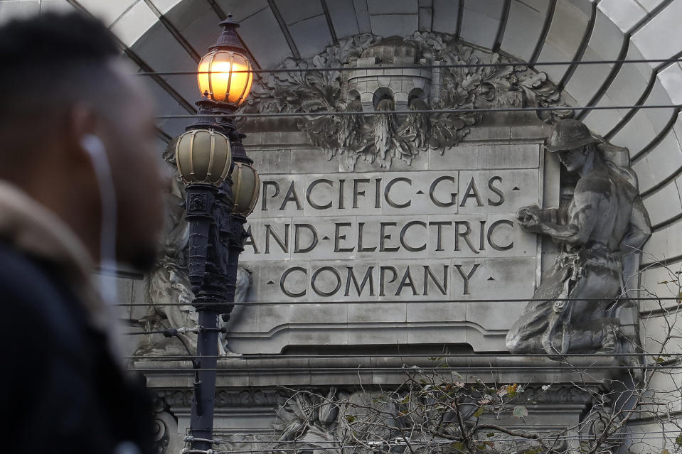 FILE - In this Dec. 16, 2019, file photo, a sign to a Pacific Gas & Electric building is shown in San Francisco. Pacific Gas & Electric is assuring a federal judge Wednesday, Jan. 29, 2020, it will meet a June 30 deadline for getting out of bankruptcy, as California Gov. Gavin Newsom signaled his intent to follow through on his threat to attempt a government takeover of the nation's largest utility. (AP Photo/Jeff Chiu, File)