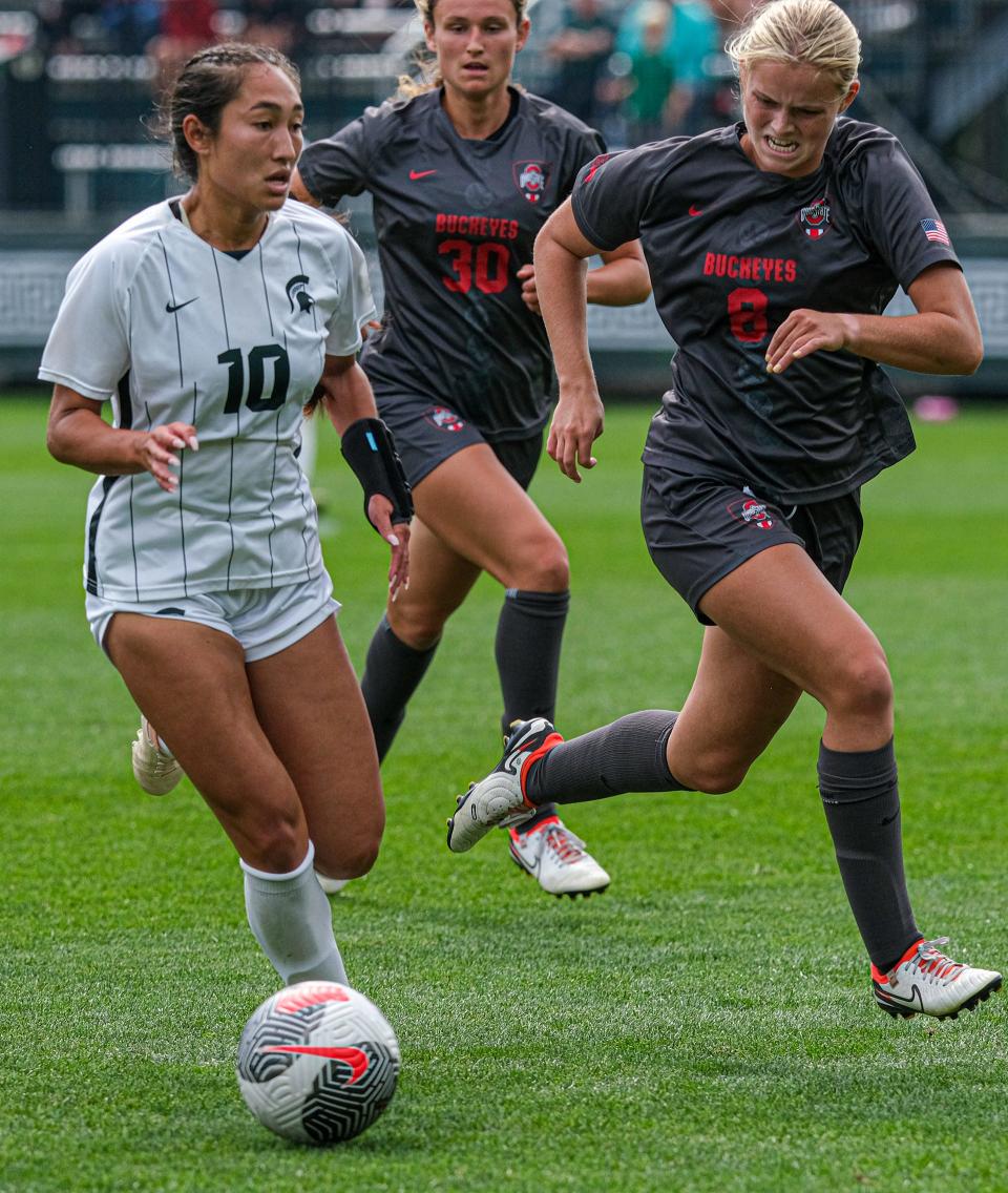 Michigan State's Alex Hargrave (10) moves the ball and is pursued by Ohio State's Brooke Otto (8) and Berkley Mape (30) Sunday, Sept. 17, 2023. The match ended in a 1-1 tie.