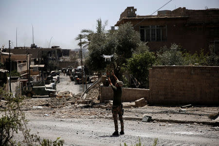 A member of Iraqi rapid response forces prepares to catch a drone used for spotting the mortar shell hits during clashes with Islamic State fighters in western Mosul, Iraq May 27, 2017. REUTERS/Alkis Konstantinidis