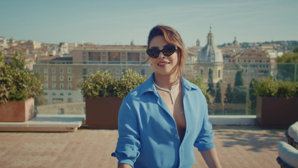 Priyanka Chopra Jonas on the Bulgari Hotel Roma rooftop, wearing a Serpenti diamond necklace, in a scene from <em>An Emperor’s Jewel — The Making of Bulgari Hotel Roma</em>.