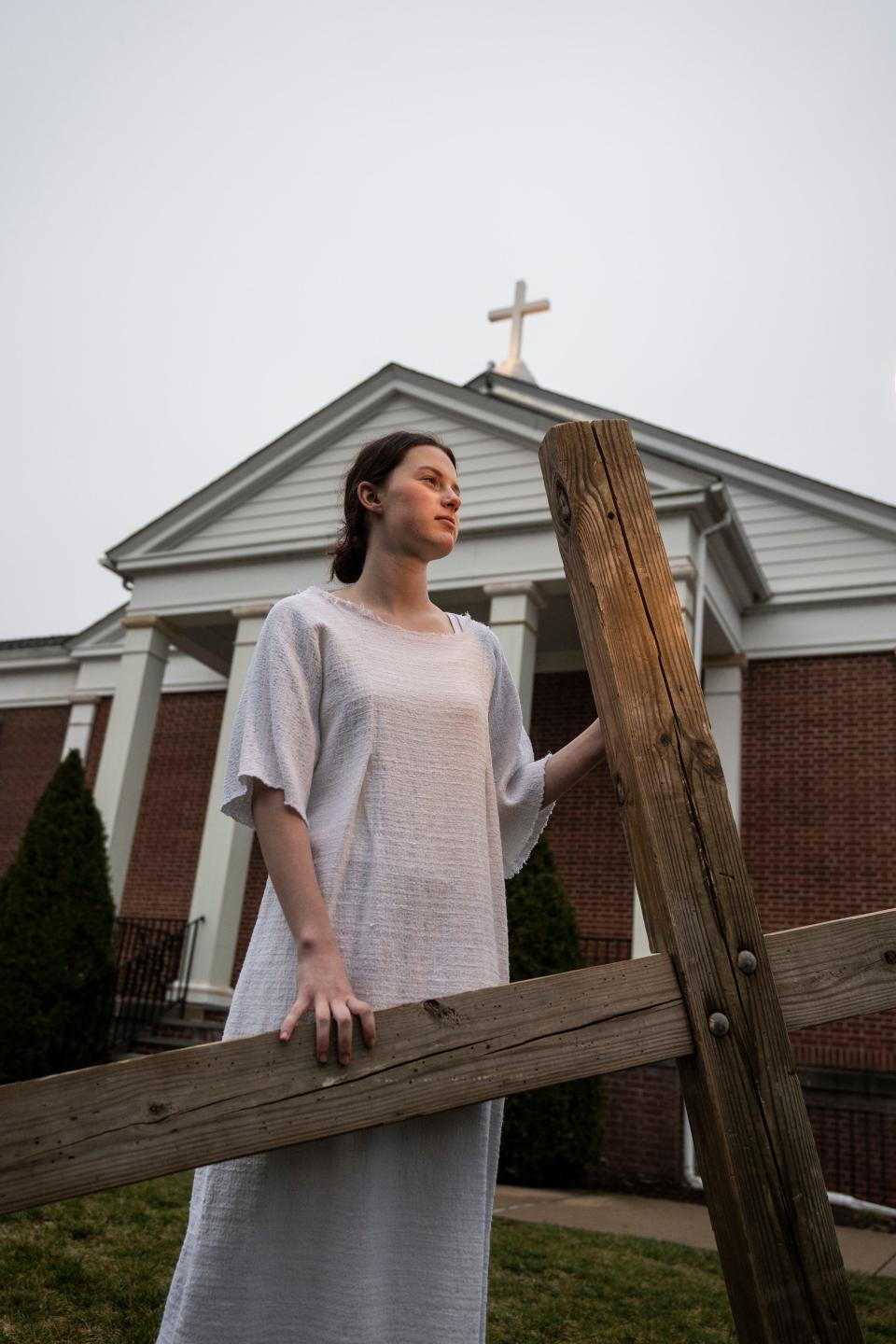 Madeline Harmon, 15, will be playing Jesus in the "Cross Carry" a play the Christian Drama School of New Jersey has been performing for more than 20 years. Harmon, dressed in her Jesus costume, holds a cross outside the Presbyterian Church of Morris Plains, where the drama school practices, on Wednesday, April 4.
