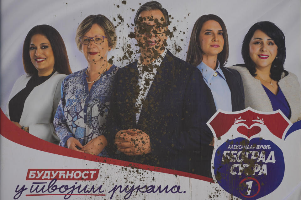 A vandalized pre-election billboard showing Serbian President Aleksandar Vucic, center, with associates, reading: "The future is in your hands" in Belgrade, Serbia, Thursday, May 30, 2024, ahead of the municipal vote set for June 2. Voters in Serbia go to the polls this weekend in a municipal election for dozens of cities and towns, including a rerun vote in the capital Belgrade where ruling populists were accused of a fraud at a previous vote in December. The right-wing Serbian Progressive Party of President Aleksandar Vucic is seen as a favorite ahead of the Sunday balloting which could further secure the strongman's already vast hold on power. (AP Photo/Darko Vojinovic)