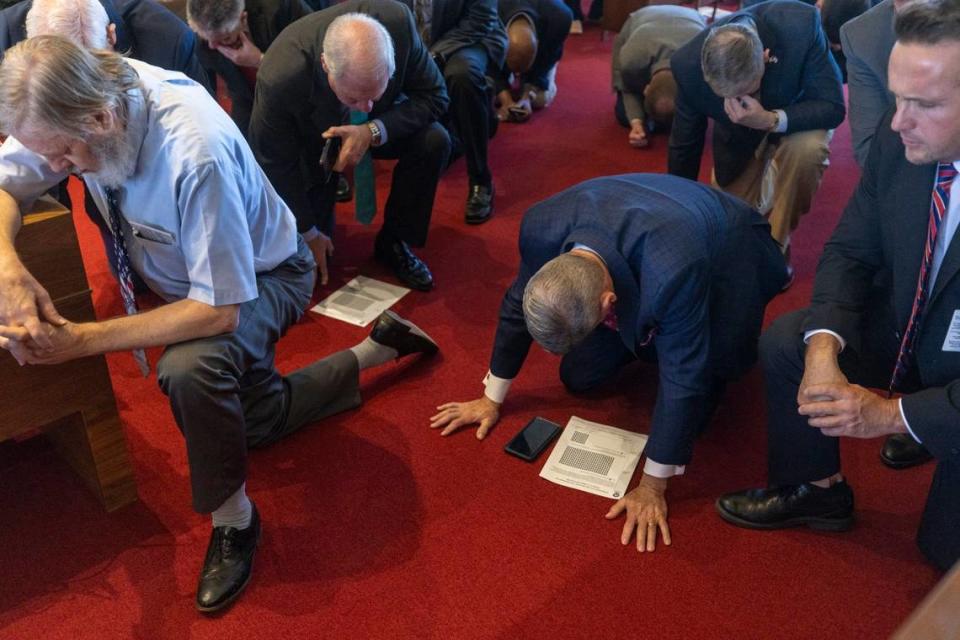 Pastor Paul Deal of Hickory, N.C., center, kneels in prayer with fellow clergy from across North Carolina after meeting with lawmakers and calling for a six week abortion ban on Tuesday, February 28, 2023 at the General Assembly in Raleigh, N.C. House Speaker Tim Moore said he was working to pass the legislation with a supermajority to prevent the governor’s veto.