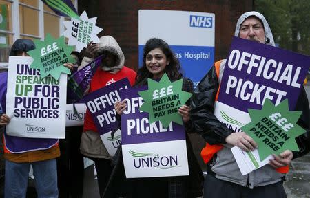 NHS workers hold placards during a strike, outside St Pancras Hospital in London October 13, 2014. REUTERS/Stefan Wermuth