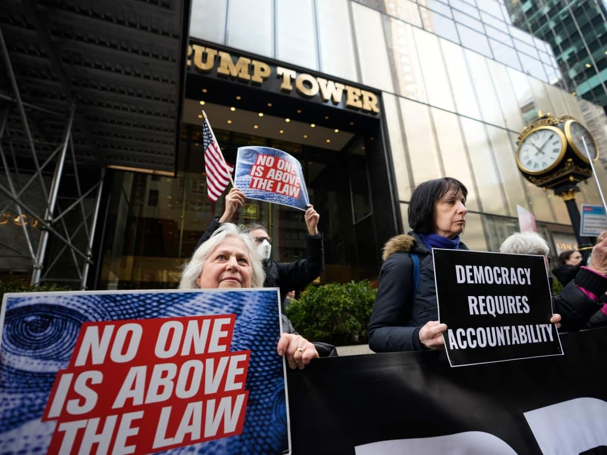 Protesters gather outside Trump Tower on Friday in New York. Donald Trump was indicted by a Manhattan grand jury, a historic first for a former president. (Bryan Woolston/The Associated Press - image credit)