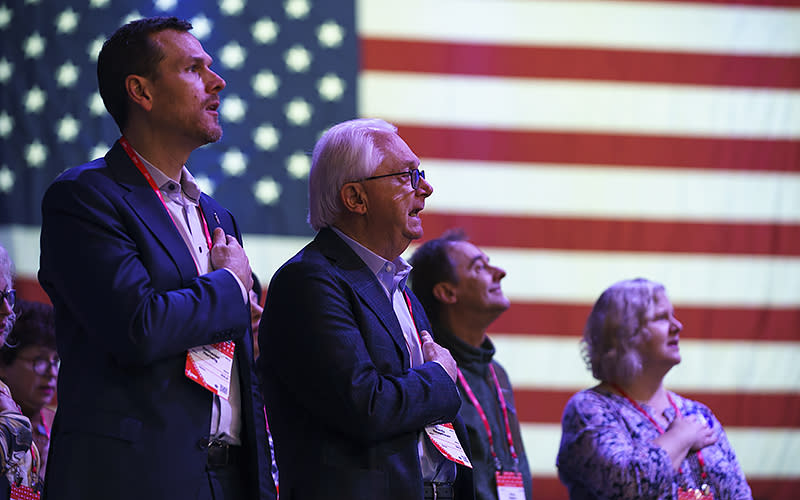 Attendees stand for the Pledge of Allegiance during the Conservative Political Action Conference (CPAC) at the Gaylord National Resort and Convention Center in National Harbor, Md., on Thursday, March 2, 2023. <em>Greg Nash</em>