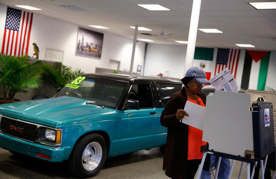 Voting in a Sam’s Auto Sales in Chicago, Ill.