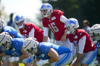 Detroit Lions quarterback Jared Goff (16) along with backup quarterbacks Tim Boyle, left and David Blough, right take a snap during a joint practice with the Indianapolis Colts at NFL football training camp in Westfield, Ind., Thursday, Aug. 18, 2022. (AP Photo/Michael Conroy)