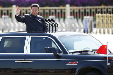 Chinese President Xi Jinping waves as he reviews the army, at the beginning of the military parade marking the 70th anniversary of the end of World War Two, in Beijing, China, in this September 3, 2015 file photo. REUTERS/Damir Sagolj/Files