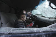 A boy cries after government airstrikes in the town of Ariha, in Idlib province, Syria, Wednesday, Jan. 15, 2020. Syrian government warplanes struck a market and an industrial area Wednesday in the last territory in the hands of rebel groups in the country's northwest, killing at least 15 people, opposition activists said. (AP Photo/Ghaith Alsayed)