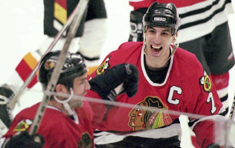 FILE - Chicago Blackhawks captain Chris Chelios, right, congratulates teammate Joe Murphy after Murphy scored the game and series winning goal for the Blackhawks at 10:02 of the third overtime period against the Calgary Flames in Calgary, April 24, 1996. The Blackhawks have decided to retire Hall of Fame defenseman Chris Chelios’ No. 7 jersey. The Blackhawks had Pearl Jam frontman Eddie Vedder deliver the news to his longtime friend during the band’s concert at the United Center on Thursday night, Sept. 7, 2023. (Mike Ridewood/Canadian Press via AP)