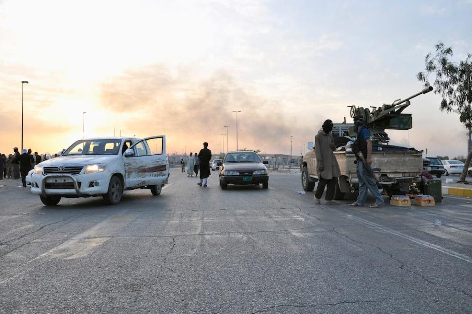 A view of an ISIS checkpoint, showing two cars and a truck-mounted artillery system on the outskirts of Mosul, Iraq, in June 2014 when ISIS first took over the city.