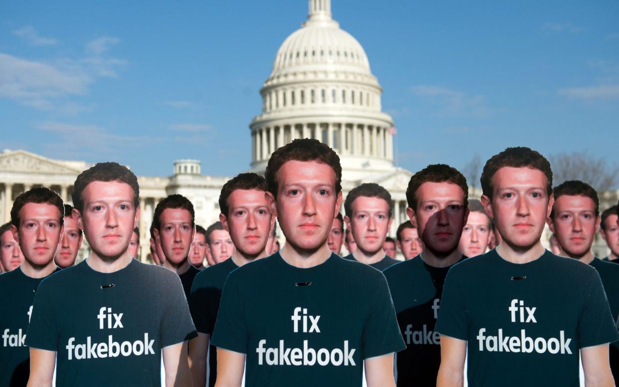 Cardboard cutouts of Facebook founder and CEO Mark Zuckerberg - SAUL LOEB/AFP