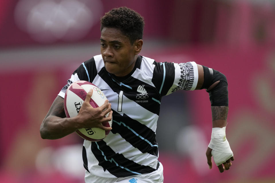 Fiji's Vasiti Solikoviti runs with the ball in Fiji's women's rugby sevens semifinal match against New Zealand at the 2020 Summer Olympics, Saturday, July 31, 2021 in Tokyo, Japan. (AP Photo/Shuji Kajiyama)