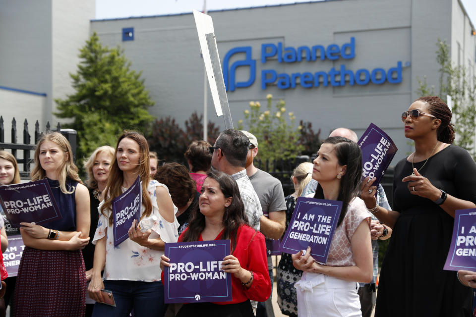 FILE - In this June 4, 2019, file photo, anti-abortion advocates gather outside the Planned Parenthood clinic in St. Louis. Missouri’s only abortion clinic has taken a legal fight over its license to a state administrative panel. The St. Louis Planned Parenthood affiliate on Monday, June 24, 2019, filed a complaint against the health department with Missouri’s Administrative Hearing Commission. The panel handles disputes between state agencies and businesses. Abortions at the clinic could end if the commission does not act before a court order protecting the procedure expires Friday. A hearing has not yet been set. (AP Photo/Jeff Roberson, File)