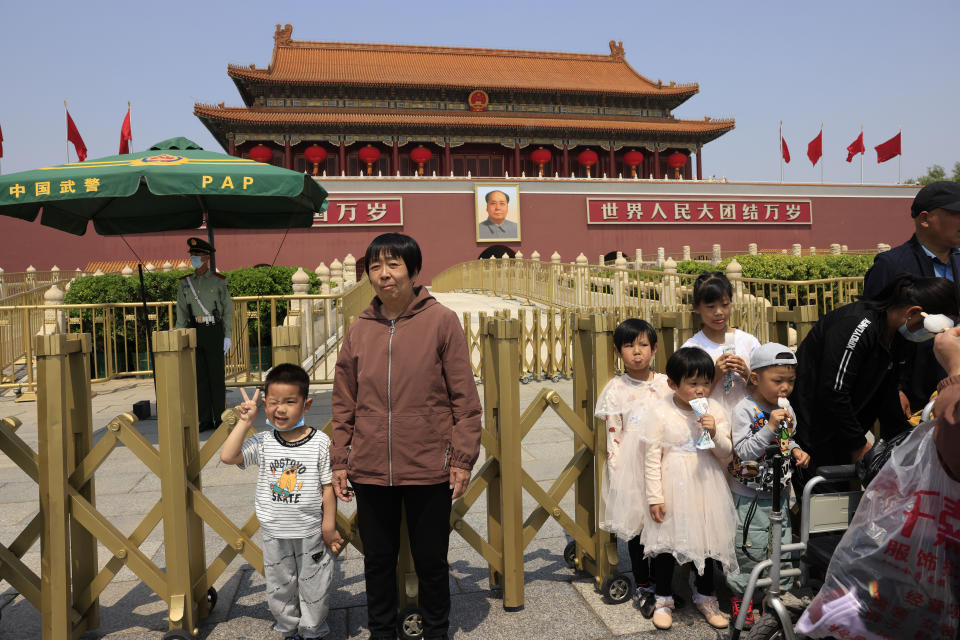 A child makes a gesture and winks as he poses for photos in front of Tiananmen Gate in Beijing on May 3, 2021. China’s population growth is falling closer to zero as fewer couples have children, the government announced Tuesday, May 11, 2021, adding to strains on an aging society with a shrinking workforce. (AP Photo/Ng Han Guan)