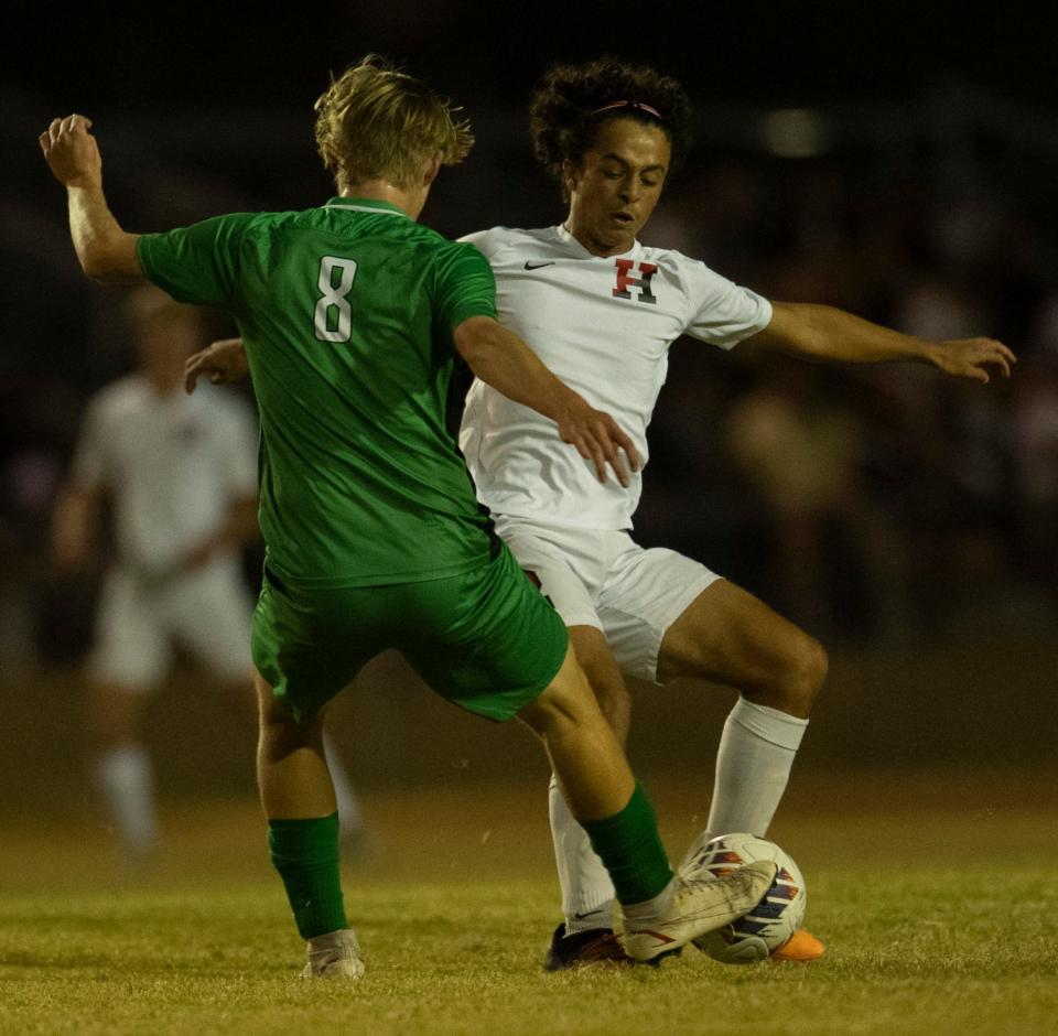 Harrison’s Santiago Arruffat (2) is defended by North’s Samuel Daugherty (8) as the Harrison Warriors play the North Huskies at Castle High School in Newburgh, Ind., Wednesday evening , Oct. 5, 2022.