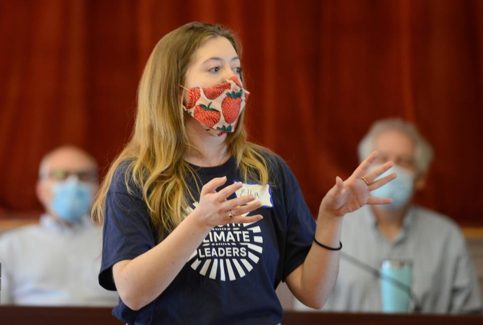 Community organizer Ella Sampou welcomes a group of students to a mock selectmen's meeting where they discussed local government and ways of responding to climate change during a Mass Audubon Youth Climate Summit in Sandwich Wednesday. Steve Heaslip/Cape Cod Times