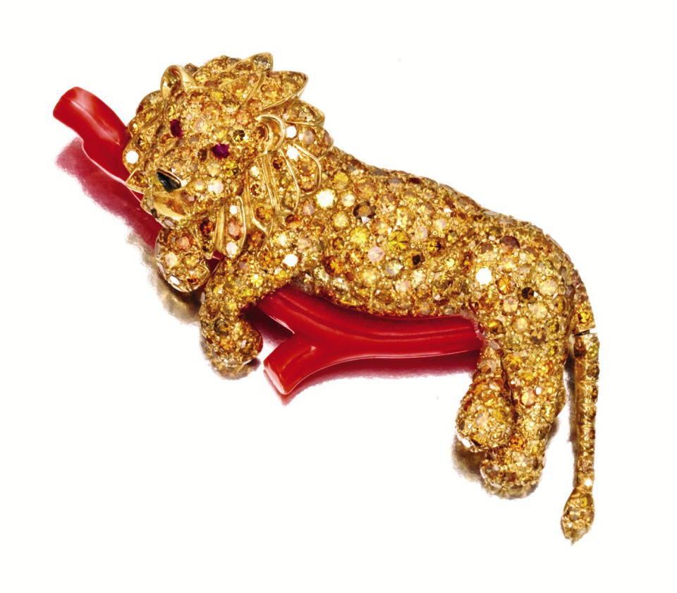 FILE - This undated file photo provided by Sotheby's shows a gold, a colored diamond, coral and ruby lion brooch that belonged to the late philanthropist Brooke Astor. The piece will be sold at an auction in New York of the late philanthropist's personal items which will include some 900 items to be offered Sept. 24-25 from Astor's Park Avenue duplex and her stone manor in Westchester. (AP Photo/Sotheby's, File)