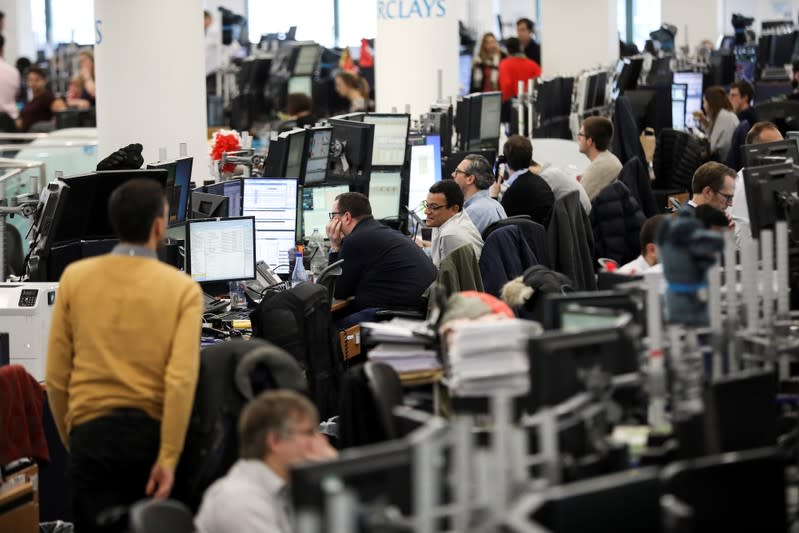 Traders work on the trading floor of Barclays Bank at Canary Wharf in London