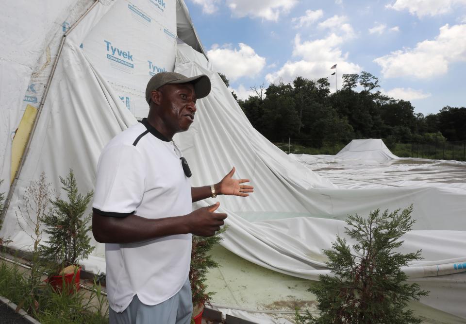 Kela Simunyola, the owner of Kela Tennis, stands next to the deflated bubble from the Mount Vernon Tennis Center at Memorial Field, Aug. 2, 2018. 