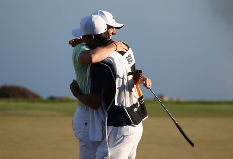 Rory McIlroy of Northern Ireland celebrates with his caddie Harry Diamond