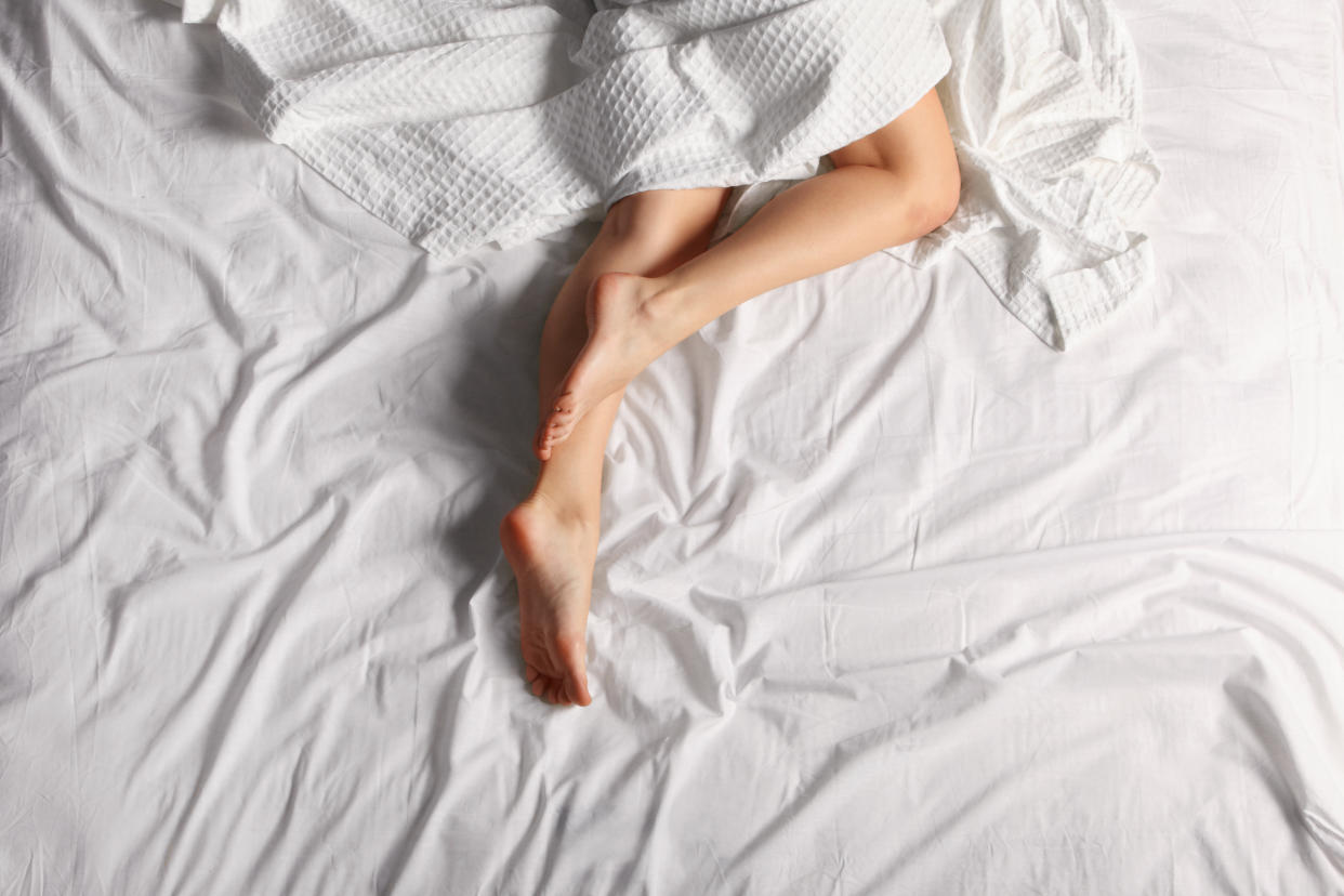 woman's legs on bed