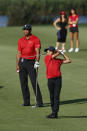 Charlie Woods, right, watches his fairway shot on the 16th hole with father Tiger Woods during the second round of the PNC Championship golf tournament Sunday, Dec. 19, 2021, in Orlando, Fla. (AP Photo/Scott Audette)