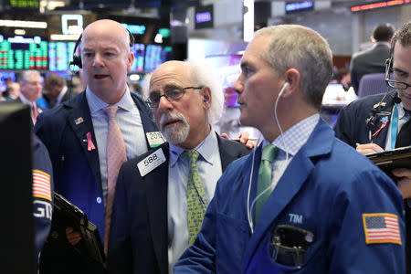 FILE PHOTO: Traders work on the floor of the New York Stock Exchange (NYSE) in New York, U.S., February 13, 2019. REUTERS/Brendan McDermid