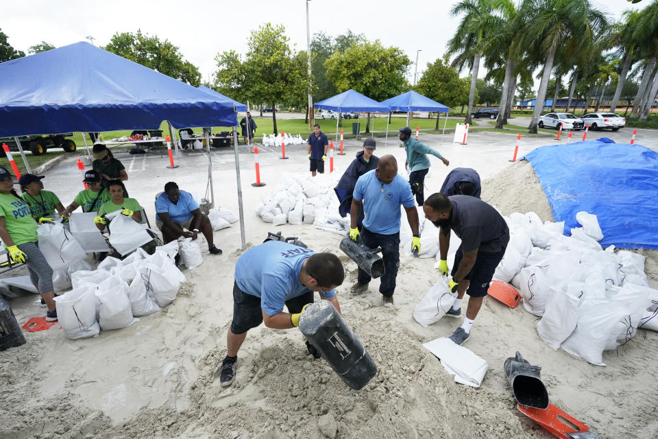 City workers fill sandbags at a drive-thru sandbag distribution event for residents ahead of the arrival of rains associated with tropical depression Fred on Aug. 13, 2021, at Grapeland Park in Miami. (Wilfredo Lee / AP)