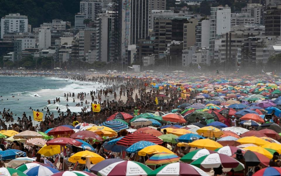 Despite restrictions to limit the spread of COVID-19, thousands crowd Ipanema Beach in Rio de Janeiro, Brazil - Bruna Prado / AP