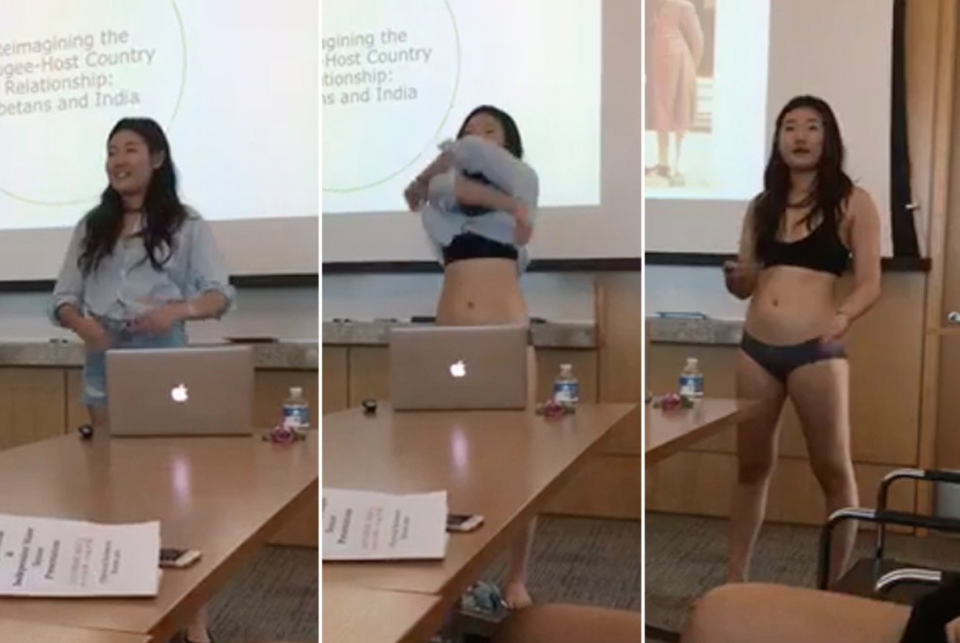 Letitia Chai strips during her presentation. Image via Twitter.