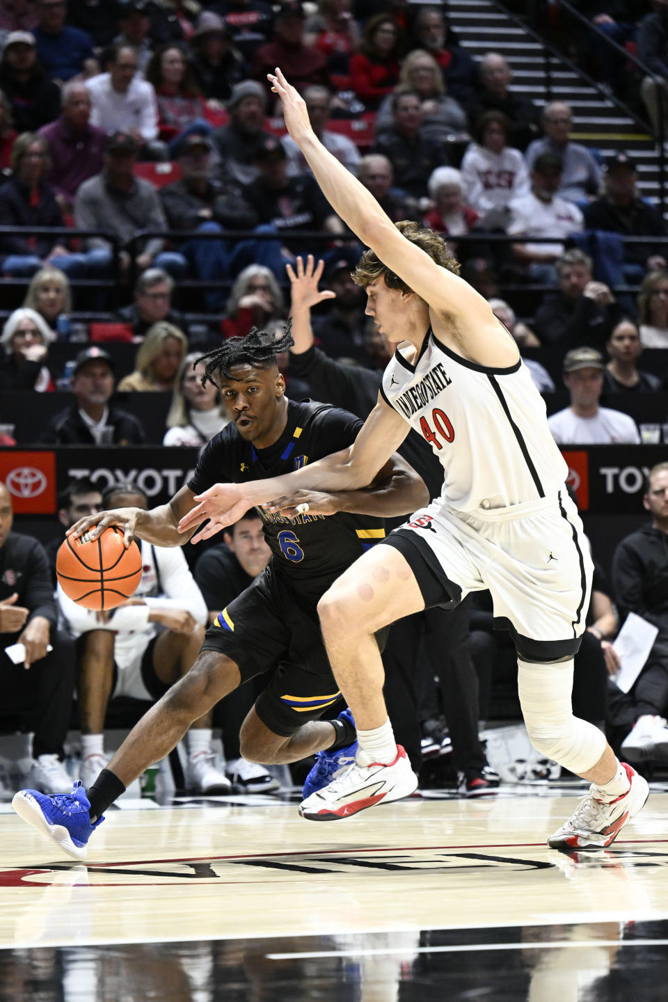 San Jose State guard Latrell Davis drives past San Diego State forward Miles Heide (40) during the first half of an NCAA college basketball game Tuesday, Feb. 27, 2024, in San Diego. (AP Photo/Denis Poroy)