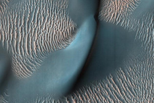 This view from the High Resolution Imaging Science Experiment (HiRISE) camera on NASA's Mars Reconnaissance Orbiter shows two classes of aeolian bedforms within Proctor Crater. The relatively bright, small ridges are ripples. From their study on Earth, and close-up examination by the MER rovers (roving elsewhere on Mars), we know that ripples are composed of fine sand (less than 200 microns in diameter) or fine sand coated with coarser sand and granules.Image Credit: NASA/JPL-Caltech/University of Arizona