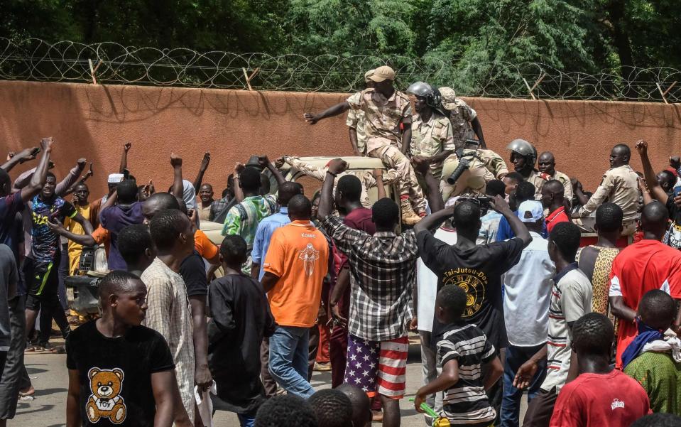 Protesters cheer Nigerien troops as they gather in front of the French Embassy in Niamey