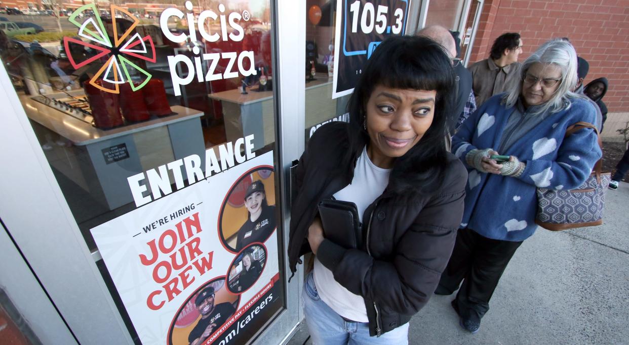 Cassandra Maddox waits with dozens of other people near the front of the line to get inside Cicis Pizza during a customer appreciation event Tuesday, Feb. 6, 2024.