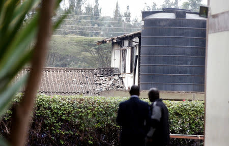 Investigators stand inside a cordon line following a fire that burnt down one dormitory of Moi Girls school in Nairobi, Kenya September 2, 2017. REUTERS/Baz Ratner