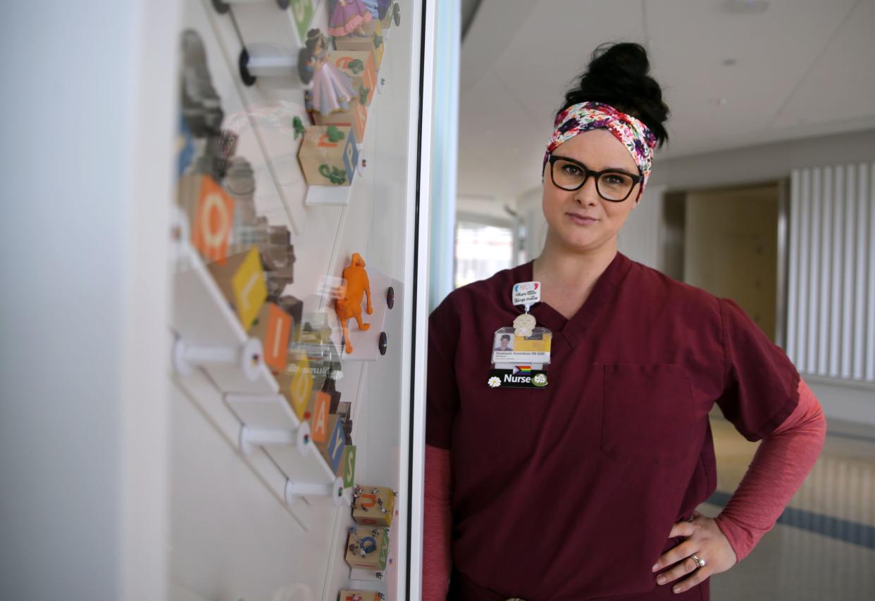 Stephanie Amundson is pictured in front of one of the art pieces at the Stead Family Children's Hospital.