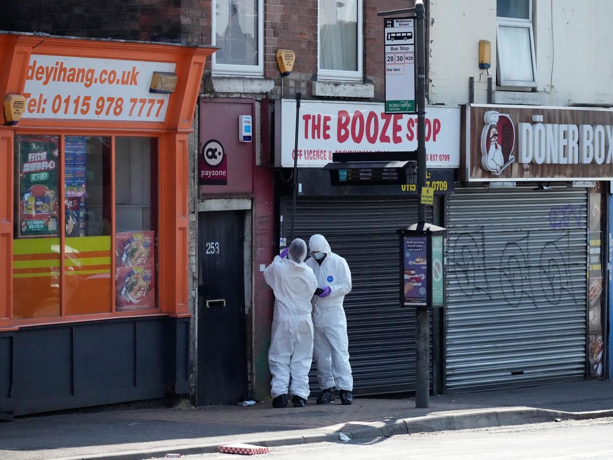 Forensic police investigate an area near shops on Ilkeston Road (Getty)