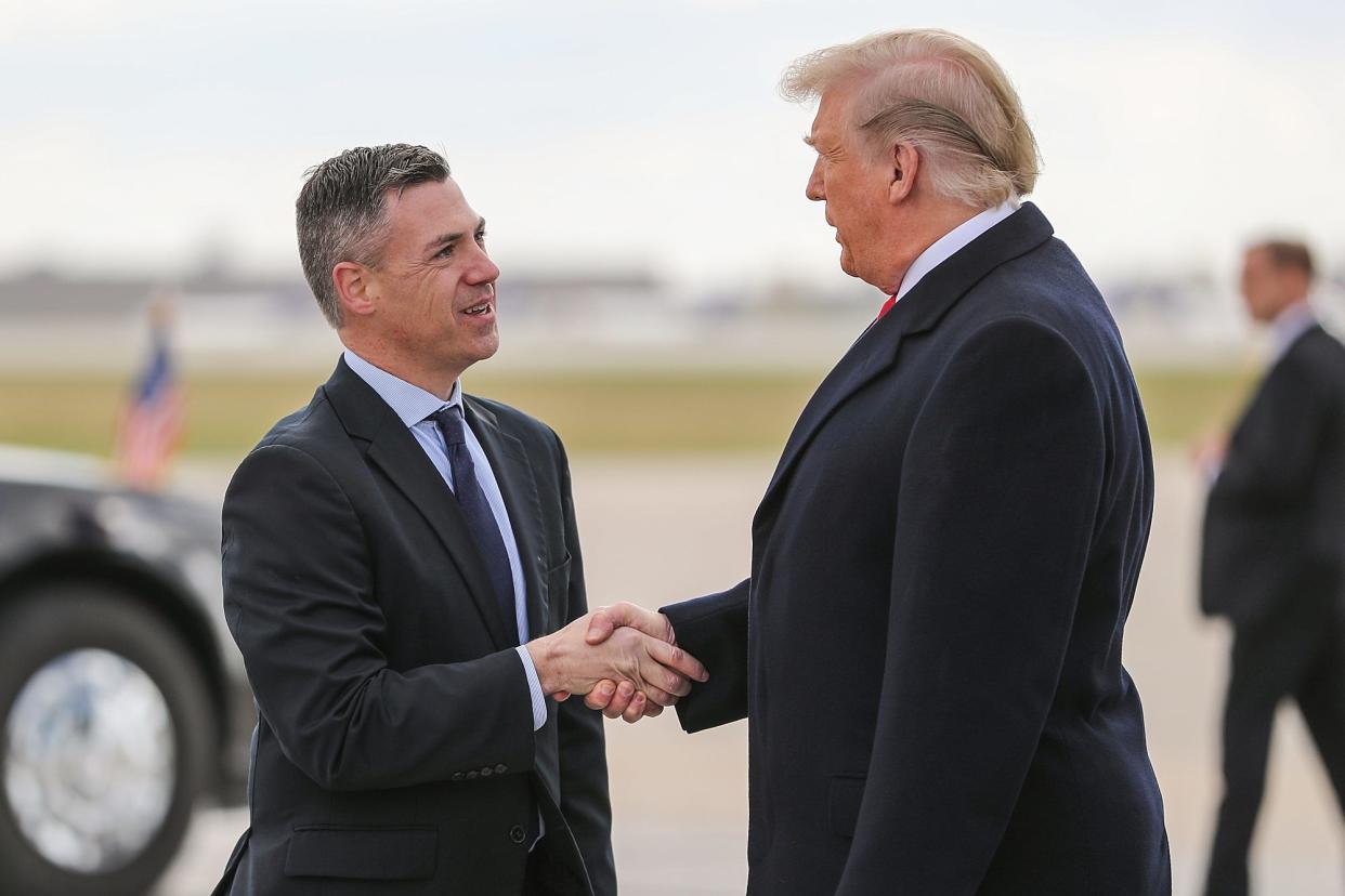 United States President Donald Trump greets Rep. Jim Banks on the tarmac at Indianapolis International Airport, where he arrived to speak at the annual Future Farmers of America Convention and Expo at Banker's Life Fieldhouse, Saturday, Oct. 27, 2018.