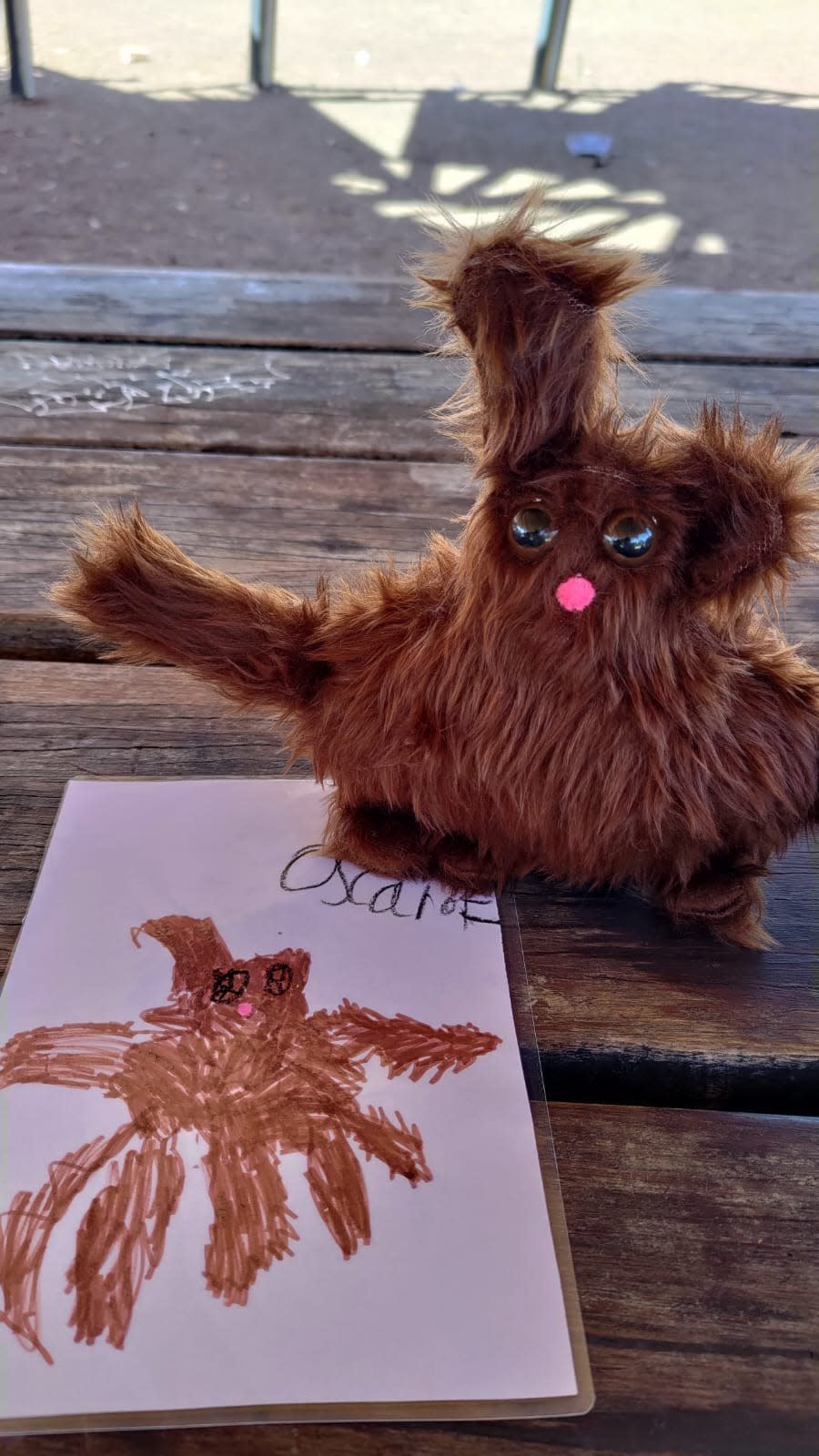 A drawing of a monster and the monster made into a toy that looks exactly like it