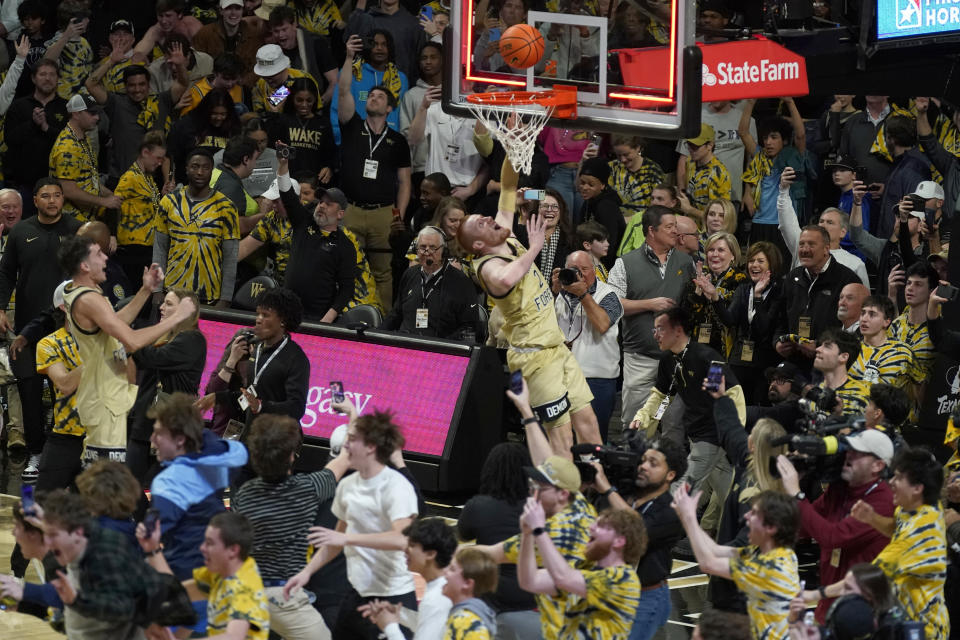 Wake Forest's Cameron Hildreth (2) drives to the basket as fans storm the court at the end of an NCAA college basketball game against Duke in Winston-Salem, N.C., Saturday, Feb. 24, 2024. (AP Photo/Chuck Burton)