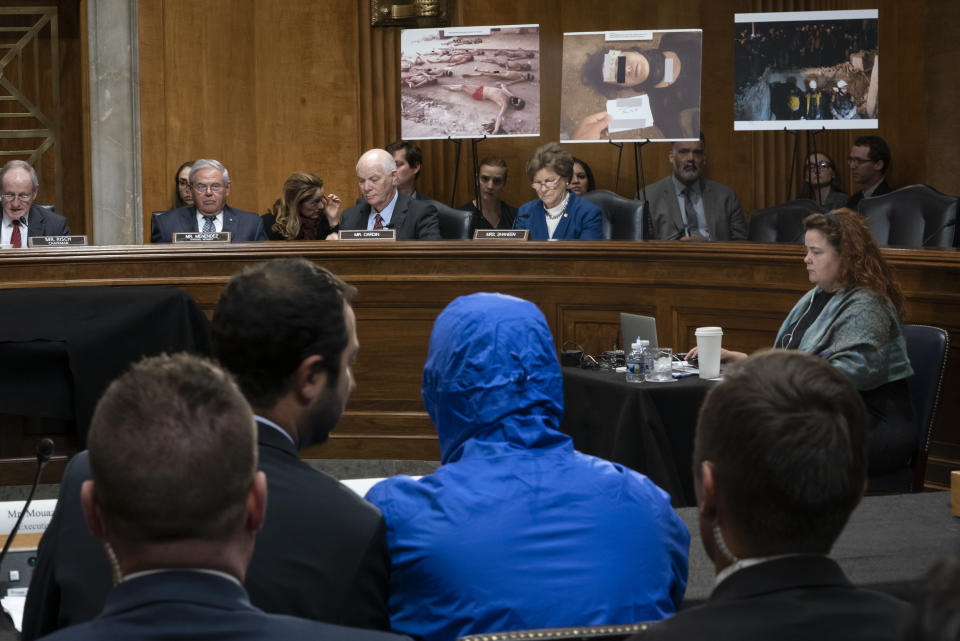 FILE - In this March 11, 2020 file photo, the Senate Foreign Relations Committee from left on the dais are Chairman Jim Risch, R-Idaho, Sen. Bob Menendez, D-N.J., the ranking member, Sen. Ben Cardin, D-Md., and Sen. Jeanne Shaheen, hears about treatment of the Syrian people from an anonymous witness they say is a Syrian military defector they are calling "Caesar" who is wearing a hood to protect him from retribution on Capitol Hill in Washington. In Syria nowadays, there is an impending fear that all doors are closing. After nearly a decade of war, the country is crumbling under the weight of years-long western sanctions, government corruption and infighting, a pandemic and an economic downslide made worse by the financial crisis in Lebanon, Syria's main link with the outside world. (AP Photo/J. Scott Applewhite, File)