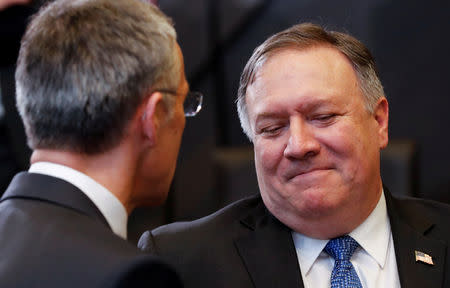 FILE PHOTO: U.S. Secretary of State Mike Pompeo and NATO's Secretary General Jens Stoltenberg speak as they attend a session during the meeting of NATO foreign ministers at the Alliance's headquarters in Brussels, Belgium, December 4, 2018. REUTERS/Yves Herman/File Photo